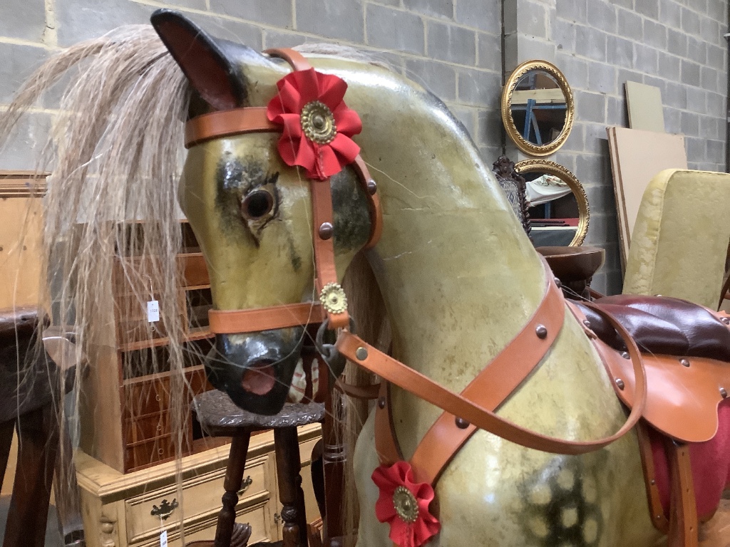 A 1920's F.H. Ayres painted wood rocking horse, on a trestle stand, fully restored in 2009 by Stevenson Bros., length 112cm height 100cm